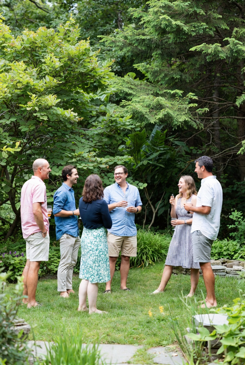 A small group of professionals gathered in conversation at a Connecticut park